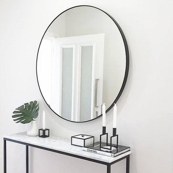 Simple black metal framed round mirror